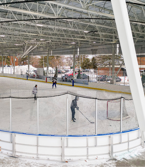 Photo of hockey rink with players practicing