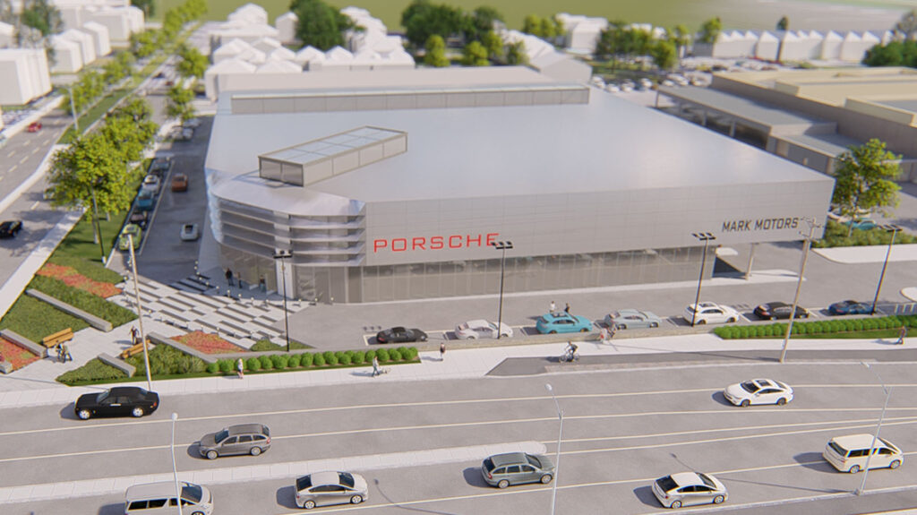 Aerial photo showing the front of a large Porsche dealership and a highway