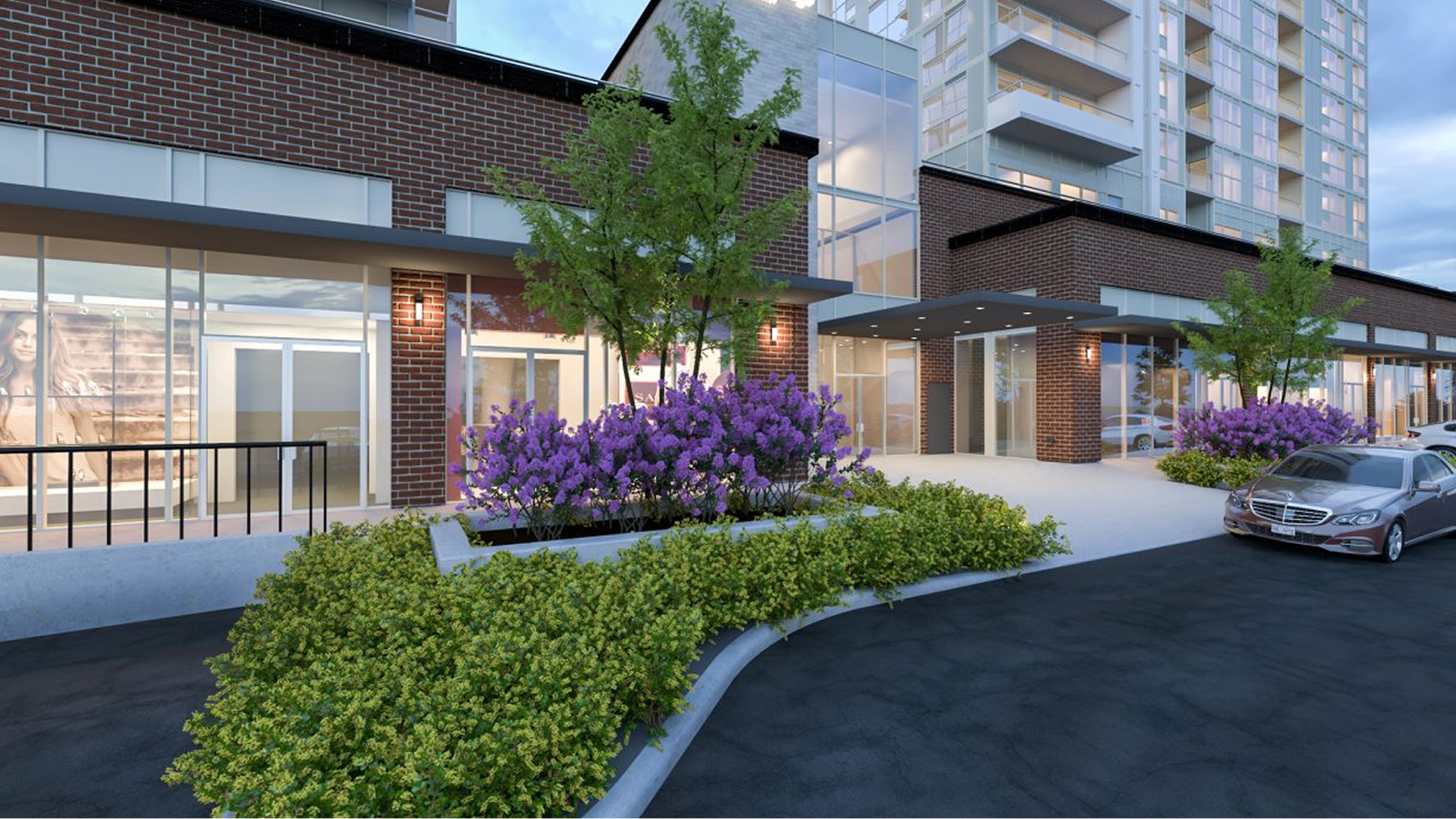 Photo of front entrance of Wellings of Whitby featuring brown brick and yellow, green, and purple foilage
